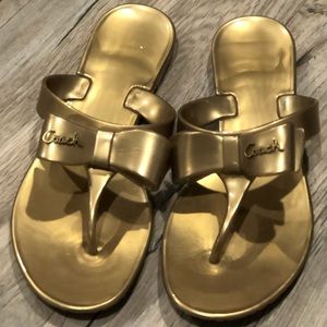 Coach gold color plastic flip flops. Size 8.
